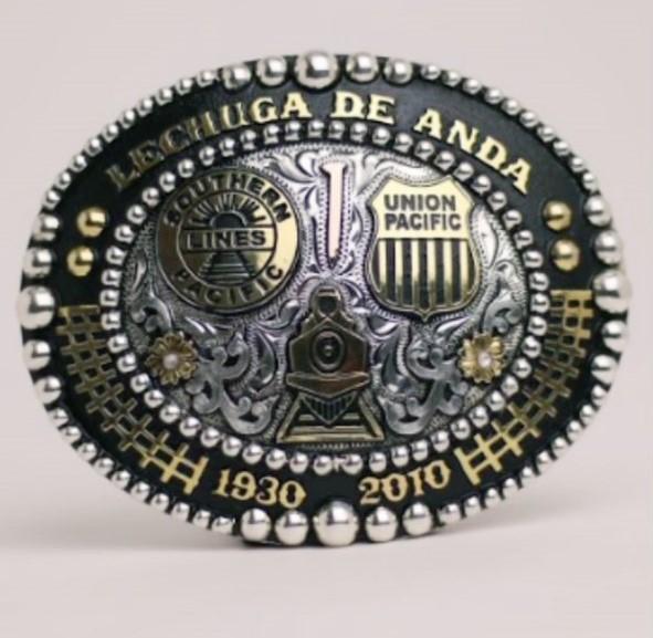 This belt buckle illustrates the story of a grandfather and grandson.