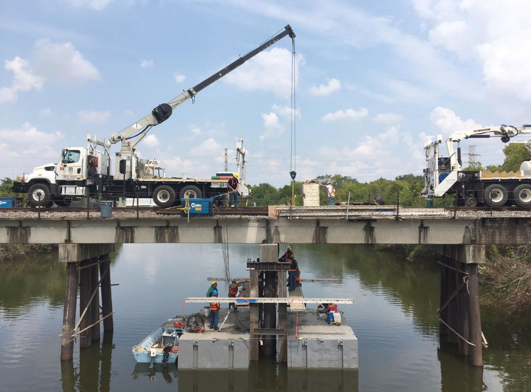 Bridge employees use a truck crane to repair a pier in Houston, Texas.