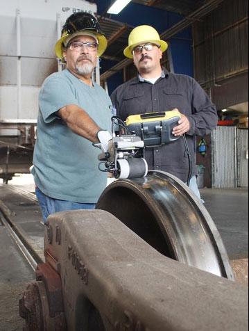 West Colton, California, Carman Welder John Moreno and Car Inspector Cesar Aguirre test a new wheel defect detector.