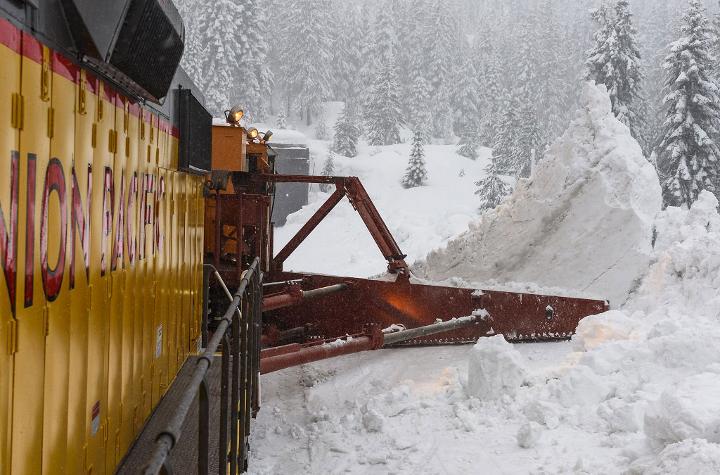 A spreader with 30-foot split wings pushes snow away from the main line at Eder, California.