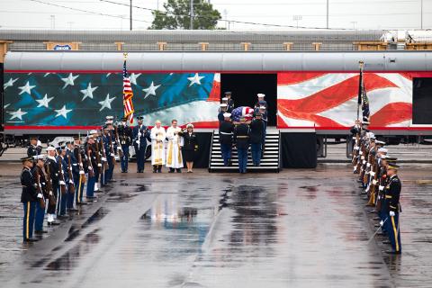 Small | President Bush's casket is carried aboard the funeral train.