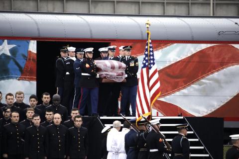 Small | President George H.W. Bush is carried off of the funeral train.