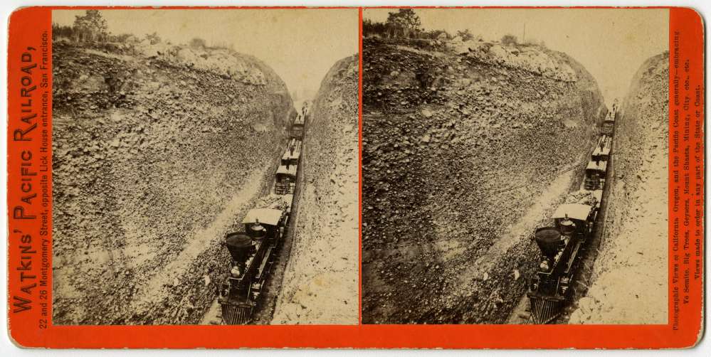 A stereo card of a train, with men standing on the cars, as it moves through Bloomer Cut near Auburn, CA