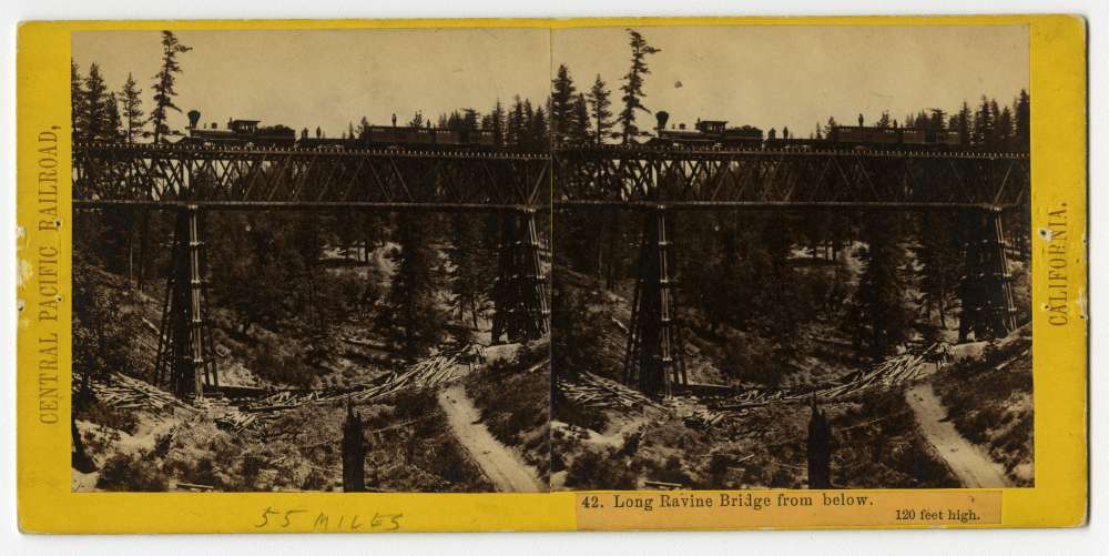 A stereo card of a train on the Long Ravine Bridge near Colfax, California
