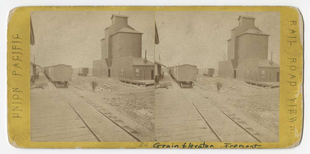 A stereo card showing a grain elevator on the Union Pacific Railroad line in Fremont, Nebraska