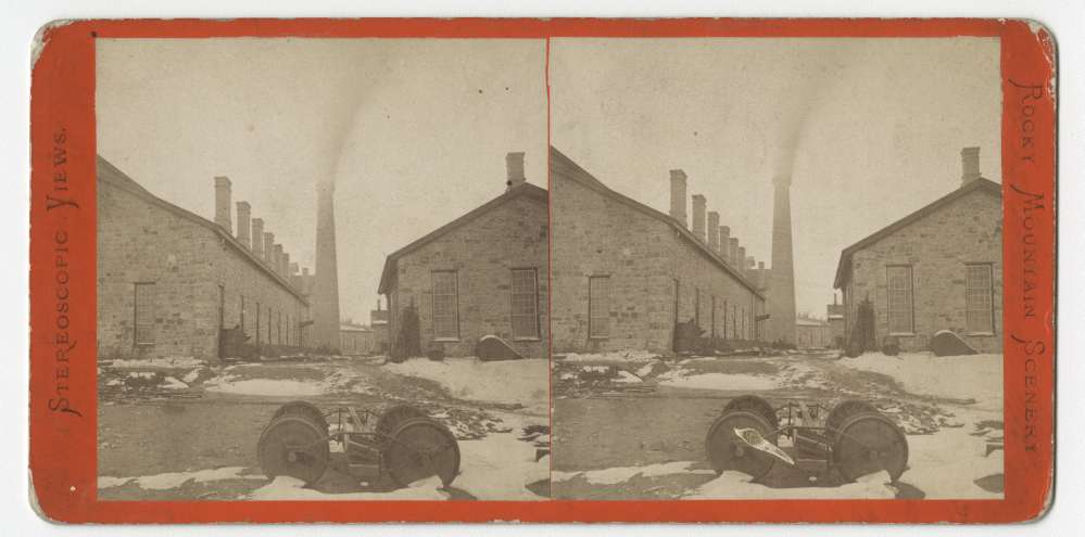 A stereo card showing the rear view of machine shops in Laramie, Wyoming
