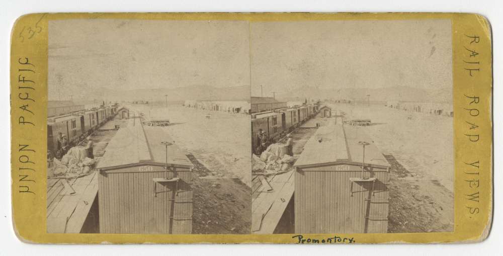 A stereo card showing the view from the top of a freight car in Promontory
