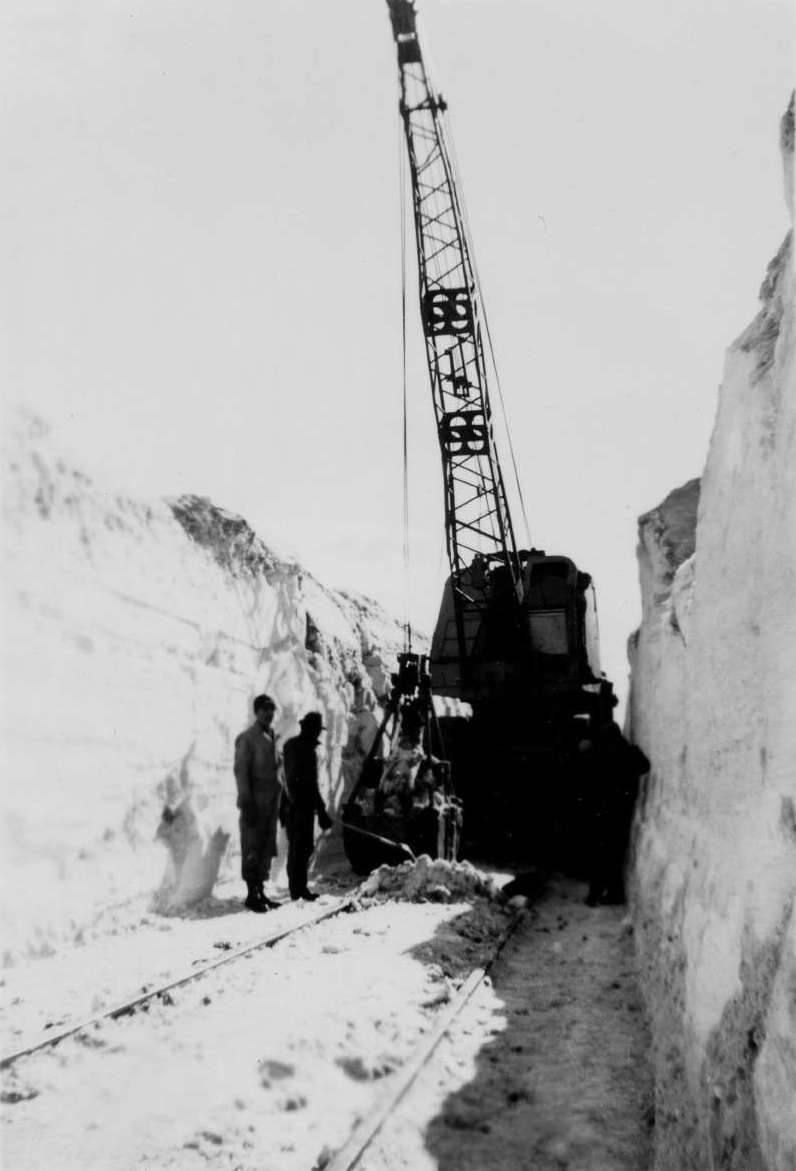 Union Pacific employees using a crane to move snow and clear the tracks after the famous 1949 blizzard