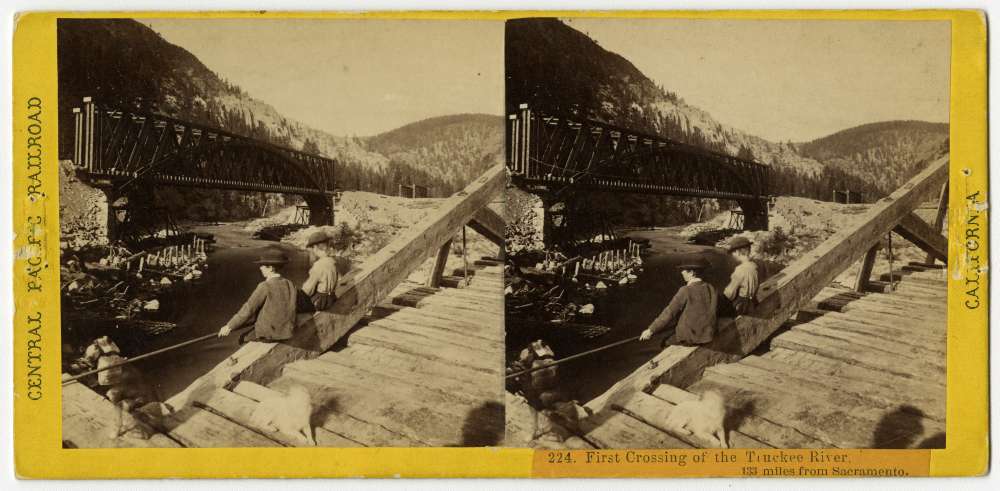 A Stereo card showing two boys sitting on a bridge across the Truckee River