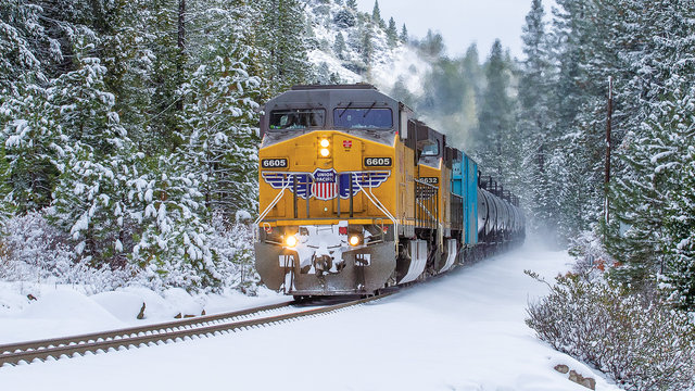 Union Pacific train operating in a snowy mountain pass