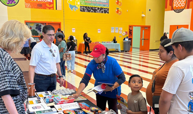Richard Zientek, senior director-Public Affairs for Union Pacific, shares rail safety information and talks with families and students during Felix Cook Jr. Elementary School’s back-to-school bash.