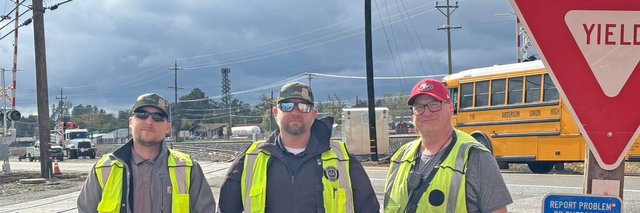 From left, Nicco Carbone, manager-Train Operations, Scott Cramer, manager-Train Operations, and Kevin Koschnick, conductor, at a ribbon-cutting ceremony to celebrate the project's completion.