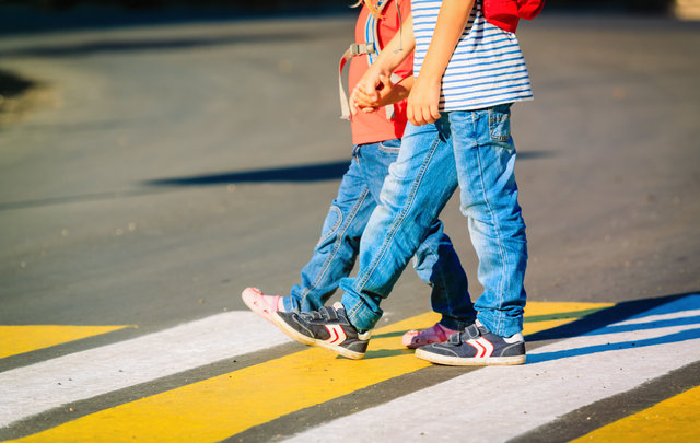 Two children using a crosswalk