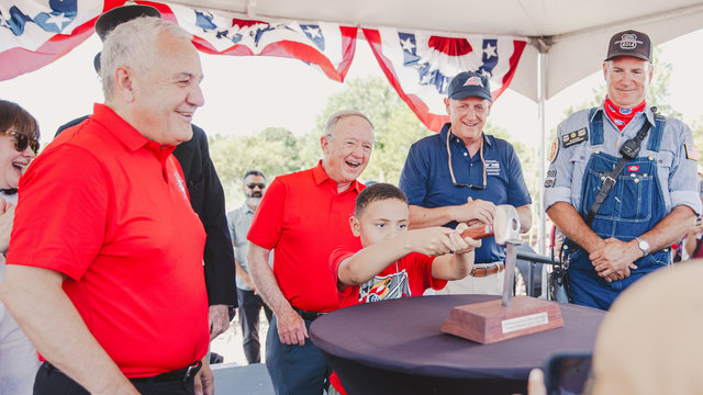 A young railfan drives the Silver Spike to conclude the ceremony