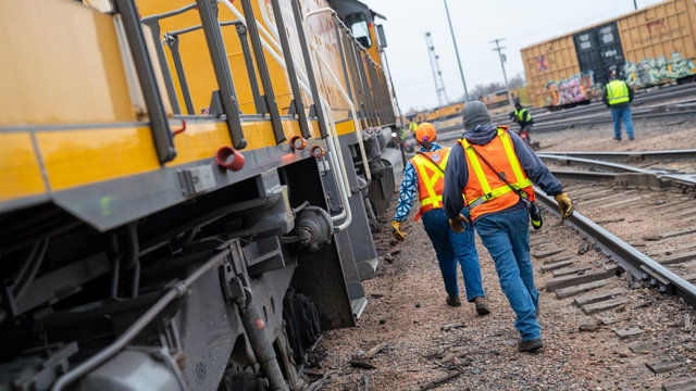 Two Union Pacific employees working safely in a rail yard