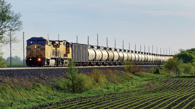 Train with tank cars going through a field | MR