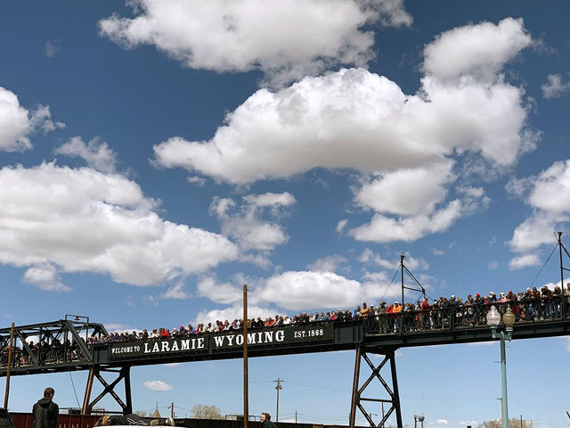 Large crowd gathered on a bridge watching Union Pacific Big Boy No. 4014 pass underneath during a public event.