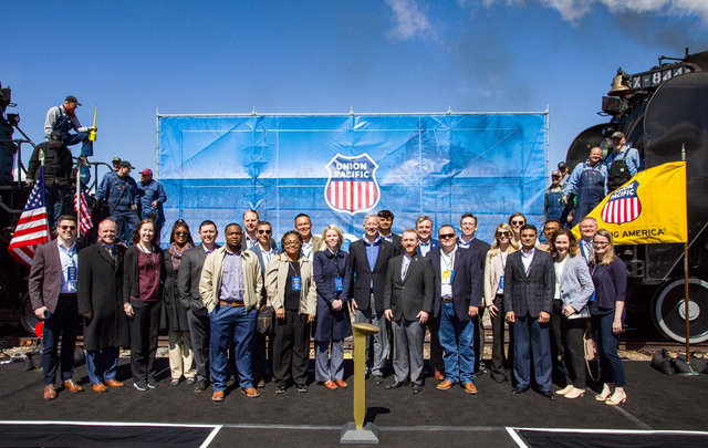 Historic group photograph at Promontory Summit, Utah, showing railroad workers and officials celebrating the joining of the transcontinental railroad.