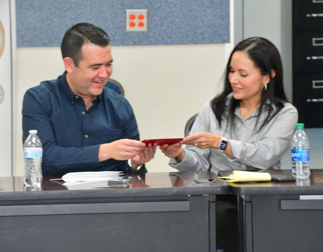 Raquel Espinoza delivers a check to suppor Eagle Pass, TX | M