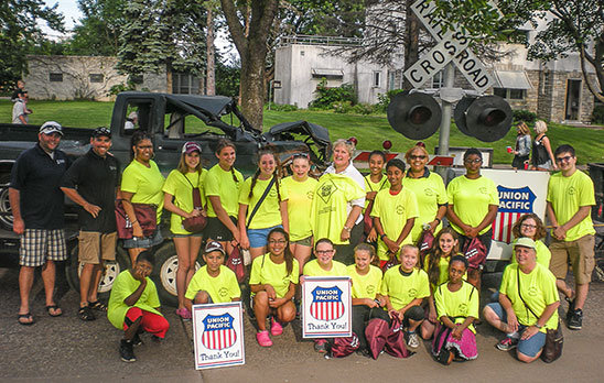 The South St. Paul Mayor's Youth Taskforce spotlighted rail safety at a South St. Paul, Minnesota, parade with a float featuring the wreckage of a truck struck by a train – part of a community-led effort supported by the Union Pacific Foundation’s Community Ties Giving Program.