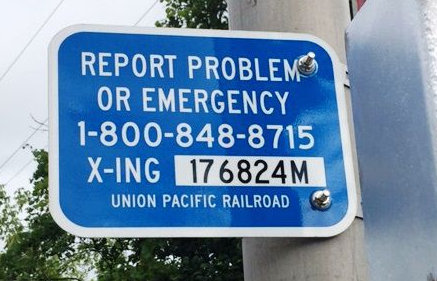 Signal with information: Report problem or emergency 1-800-848-8715 X-ING 176824M. Union Pacific Railroad