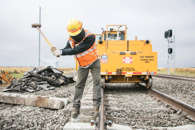 A Maintenance of Way employee works on a ballast and tie restoration project in Columbus, Nebraska.