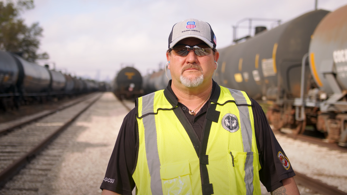 Todd Barras, locomotive engineer, Houston, stands in train yard. | LR