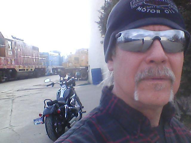 McMullen in the Denver Rock Island Railroad Yard in 2013 with his Harley and old Rock Island units.