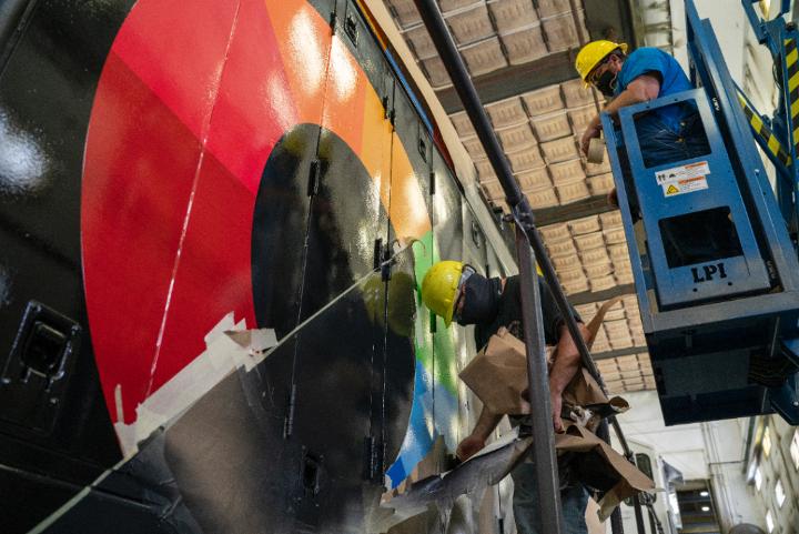 McKinney peels locomotive painters tape from UP No. 1979, with Bateman assisting from above.