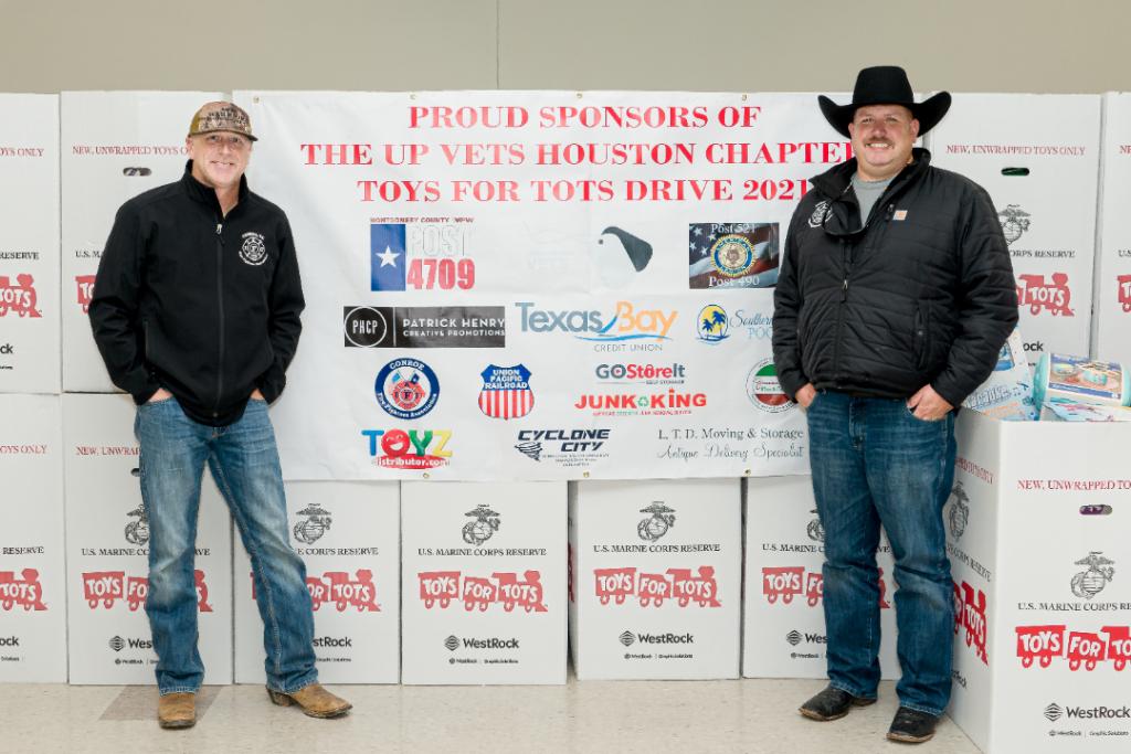 Members of the Conroe, Texas, Fire Fighters Association, one of the event sponsors, stand with the boxes of donated toys.