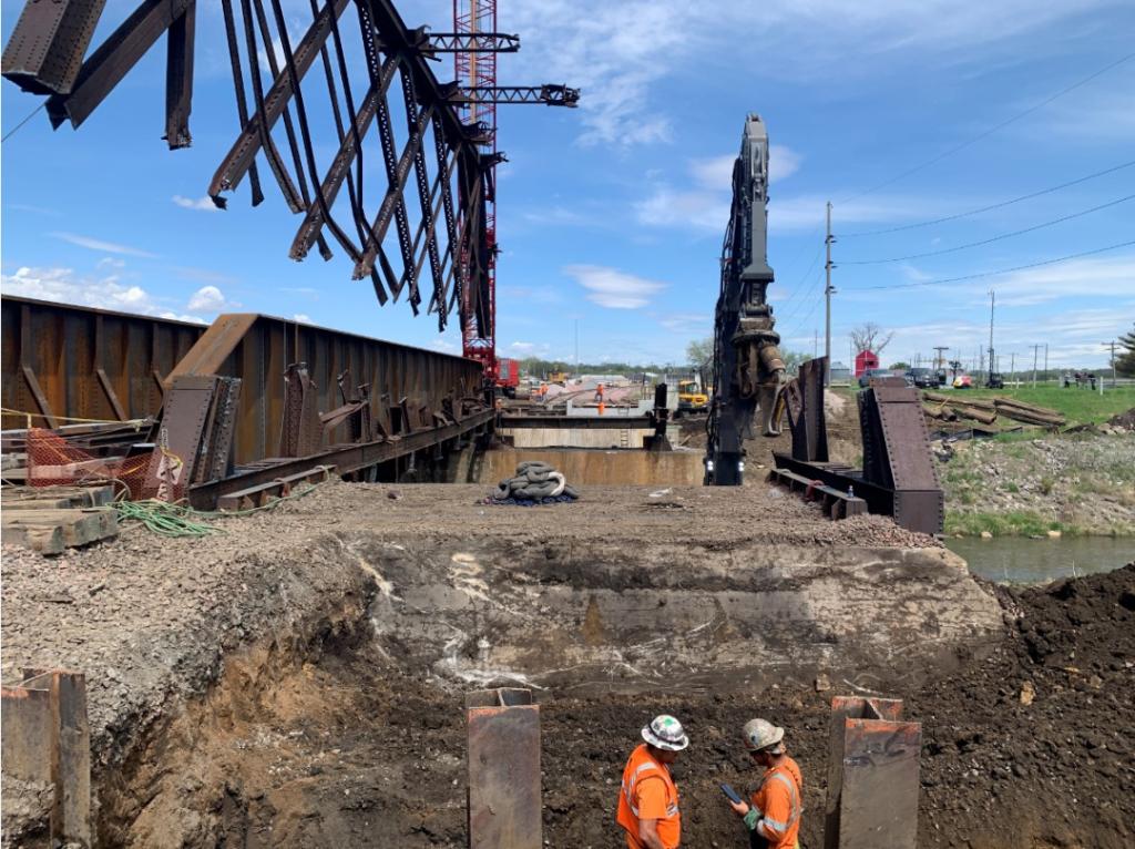 Cranes suspend part of old 110-year-old bridge in Denison, Iowa