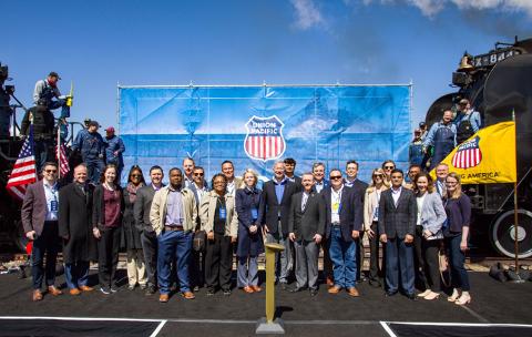 Group poses on stage with No. 4014 and No. 844 locomotives