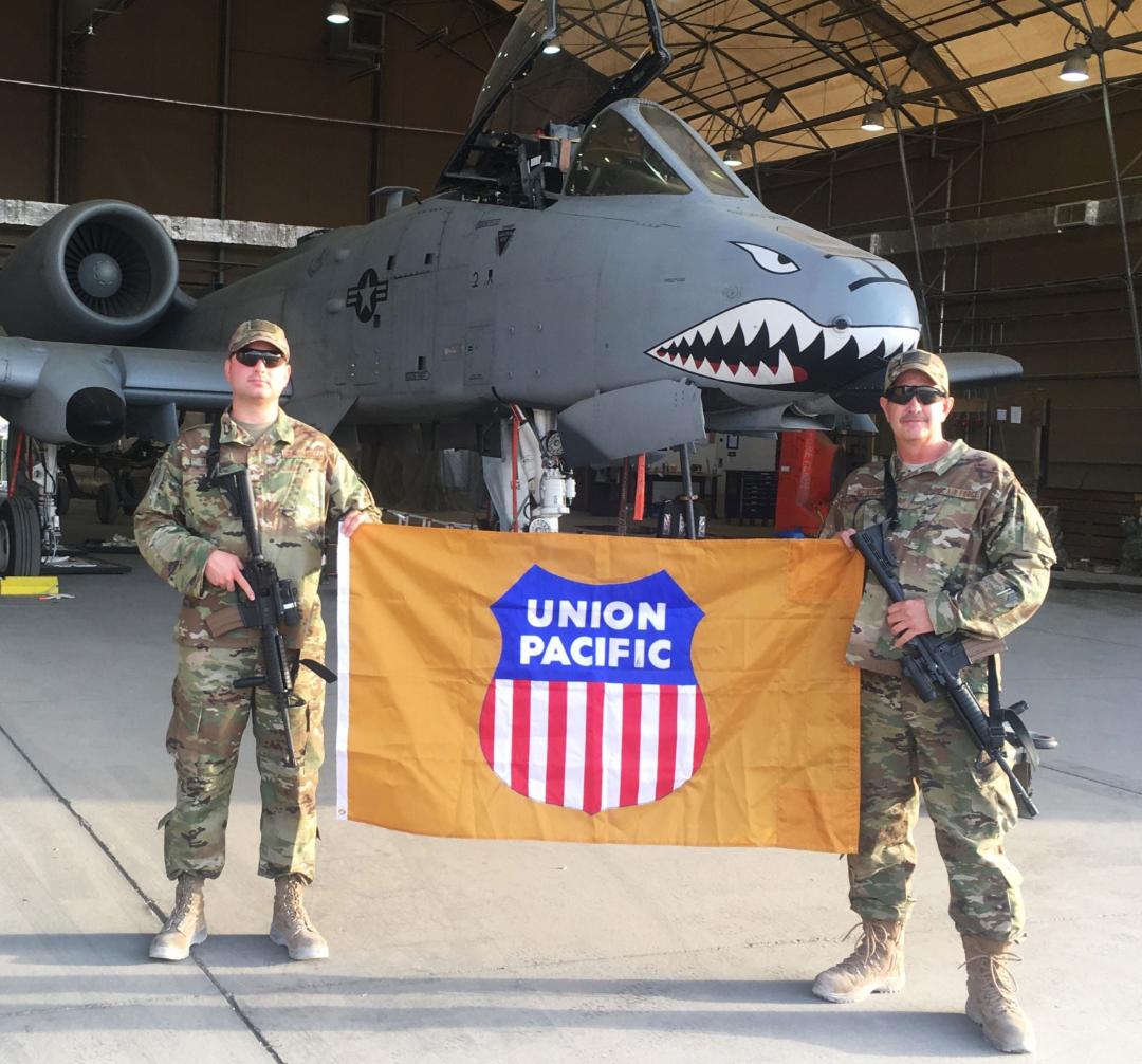 From right, Carman Welder Robley McIntosh, Dupo, Illinois, and a fellow Air National Guardsman holding a Union Pacifc fag while deployed in Afghanistan.