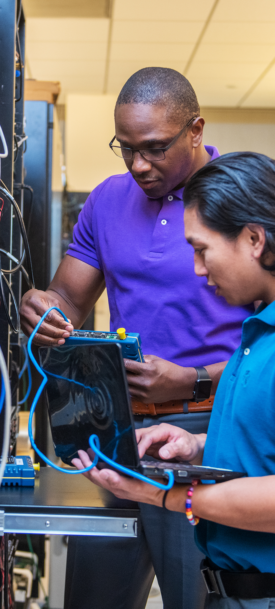 Information Technologies Project Engineers Saikou Camara, left, and Aris Garcia work in the research and development lab in Omaha, Nebraska.