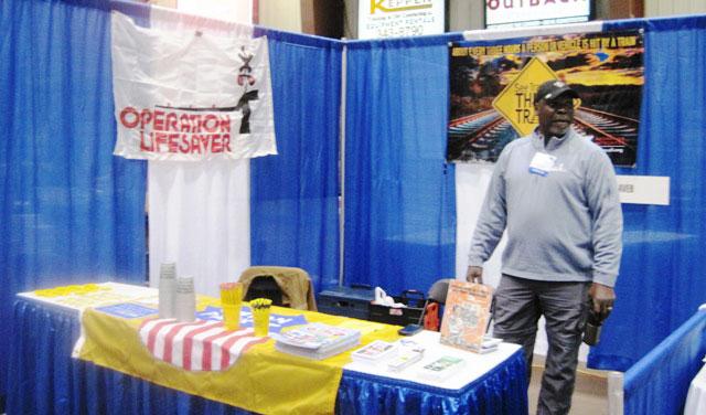 Locomotive Engineer JT Fenceroy discusses rail safety at the 2018 Louisiana Agricultural Expo in Shreveport, Louisiana, with sugar cane farmers and sugar industry members.