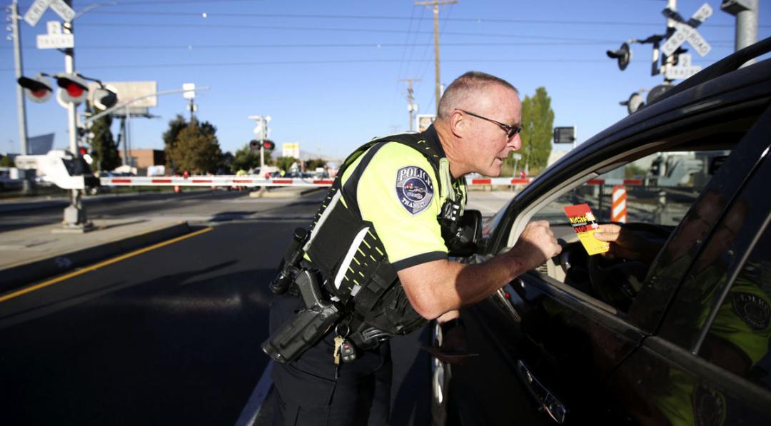 Utah Transit Authority Offcer Andy Campbell talks to a driver about railroad safety during “Operation Clear Track” in Salt Lake City, Utah.