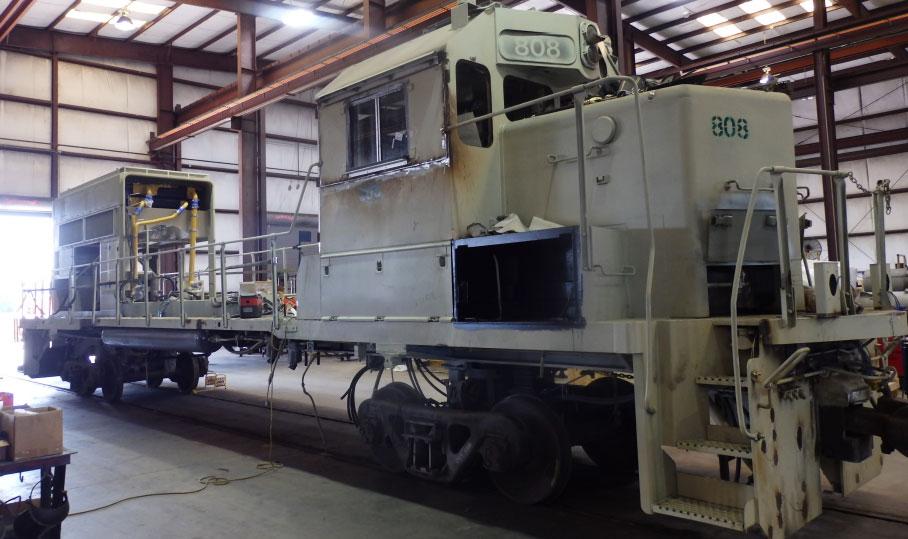 A stripped-down switcher locomotive waits to be repowered into a new Tier 4 switcher.