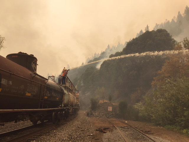 Northern California Service Unit employees between James and Pulga, California, use one ofmany “water cars” staged across the service unit to spray surrounding track.