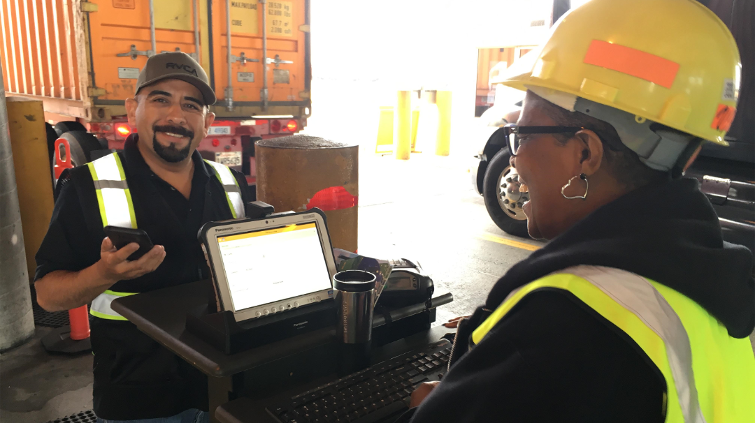 Gate Clerk Vernadine Johns, right, assists a driver with check-in at the ICTF intermodal facility in Long Beach, California.