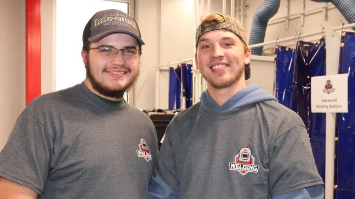 Westside High School seniors Nathan Kershaw, left, and Carson Brownfield gave tours of the new engineering lab following the dedication and steel cutting ceremony.