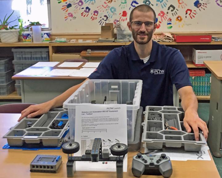Fifth and sixth grade teacher Chris Stollfus shows off a VEX robotics kit, allowing students to build and program task-oriented robots.