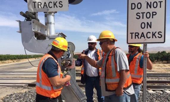 Workforce Resources Senior Instructor Archie Niebres provides signal training to three Engineering signal maintainers: Andrew Cerda, Jack Juanillo and Gerardo Monge.