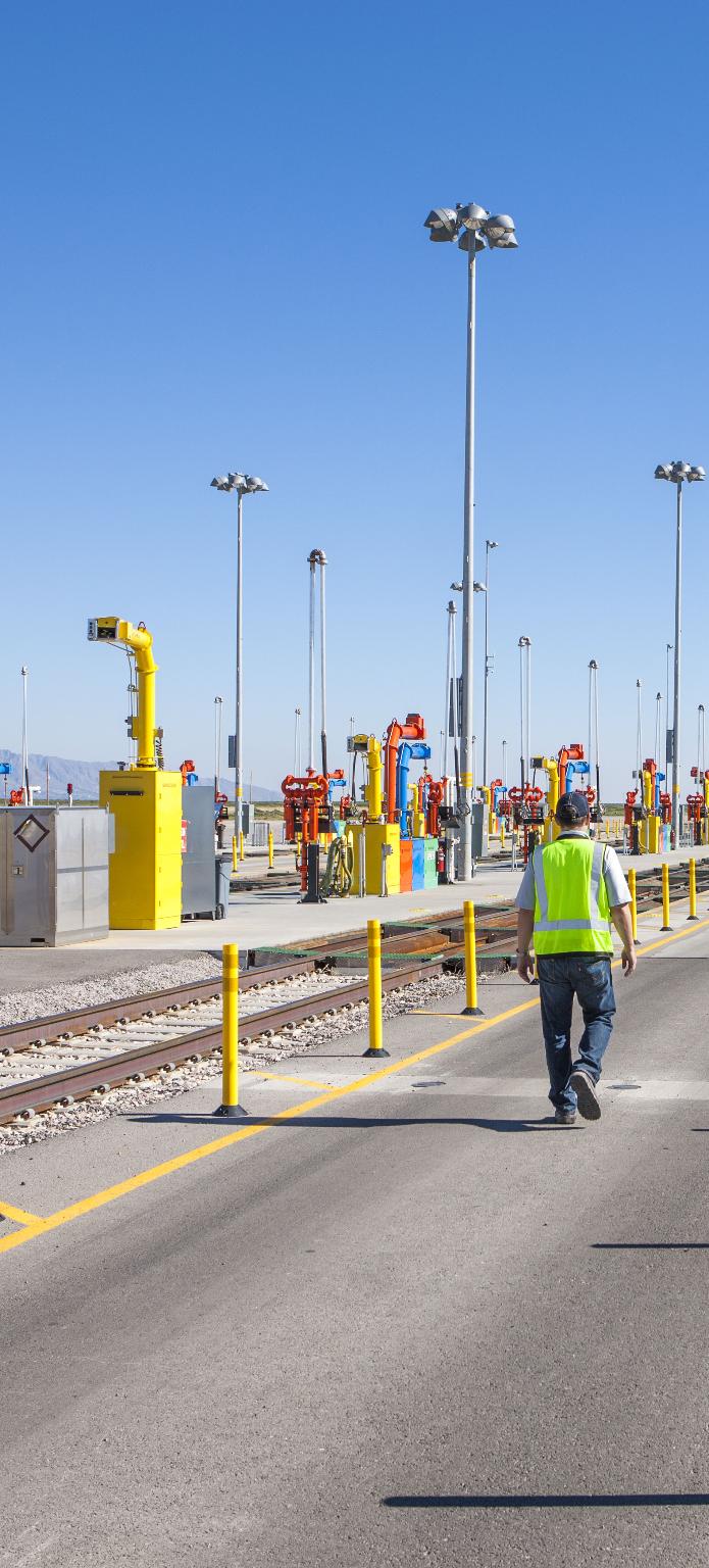 An employee awaits the next locomotive for fueling at Union Pacific’s Santa Teresa Intermodal Facility in Santa Teresa, New Mexico.