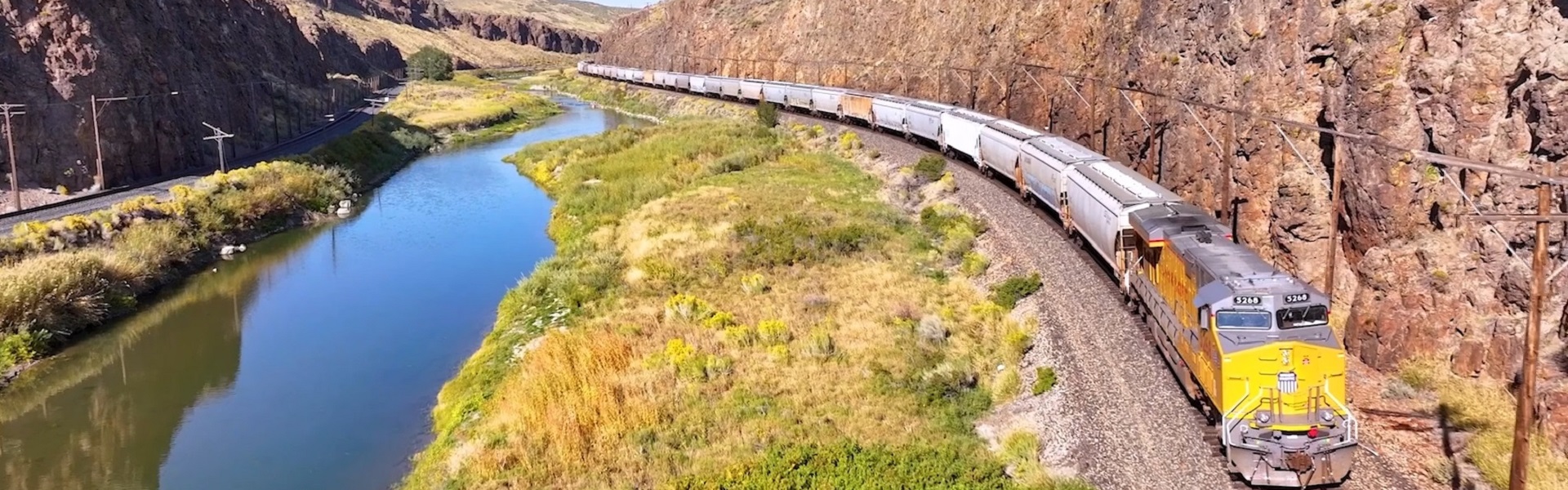 Union Pacific train passing through mountains and streams