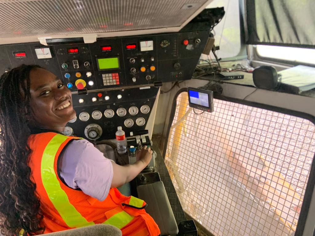 Mariam Okunubi at the controls of a ballast undercutter