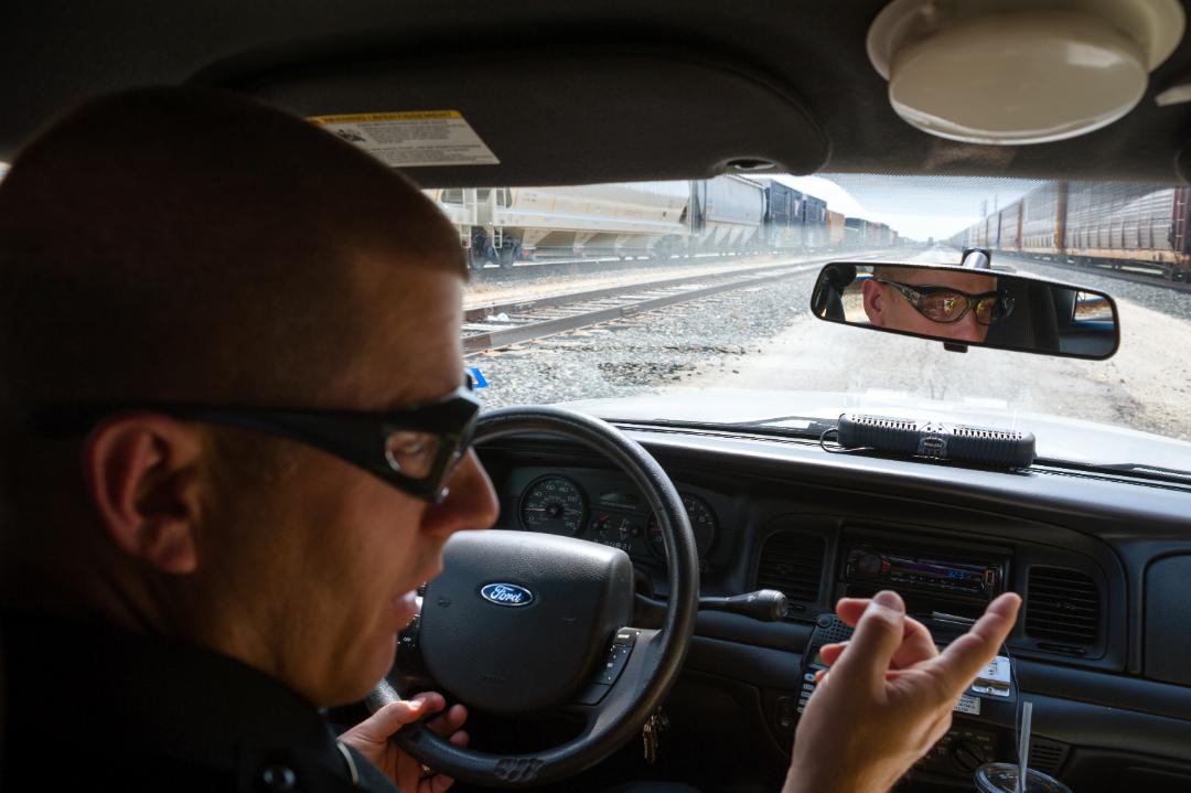 Special Agent Kevin Wells patrolling in his car.