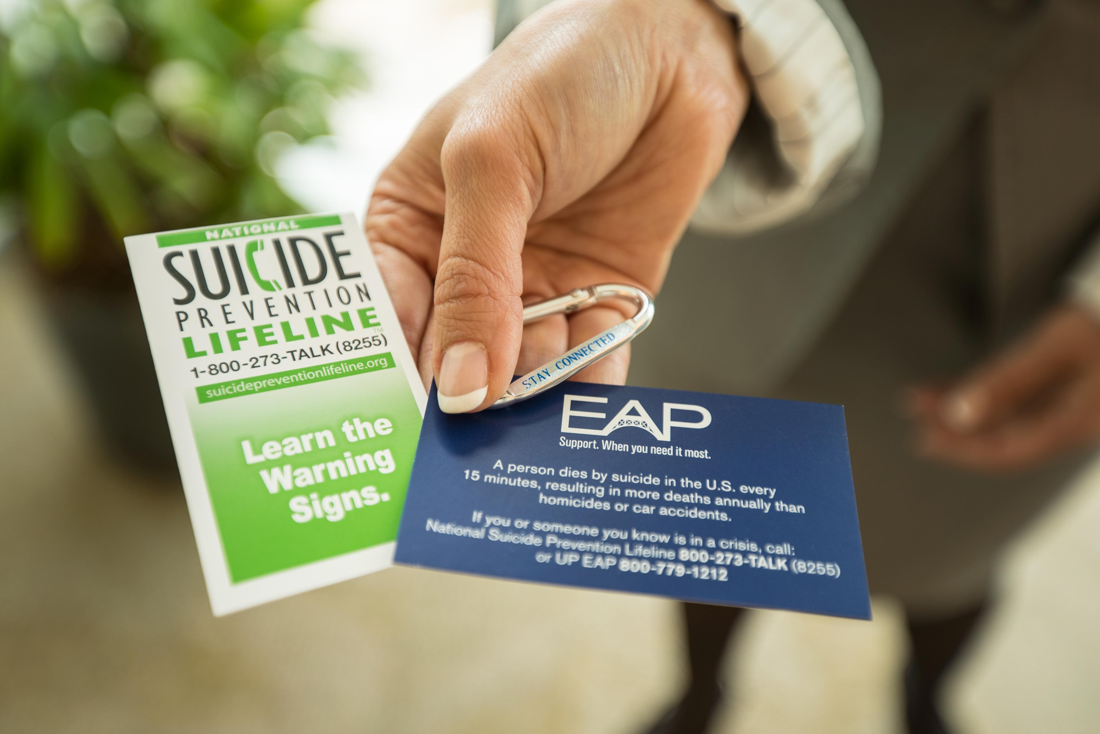Raquel Espinoza holds EAP suicide prevention handouts.