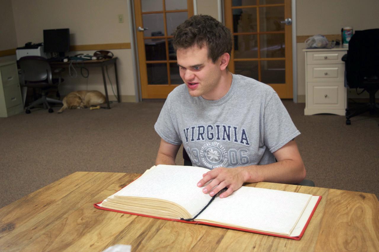 Matt Wallace reads Braille.