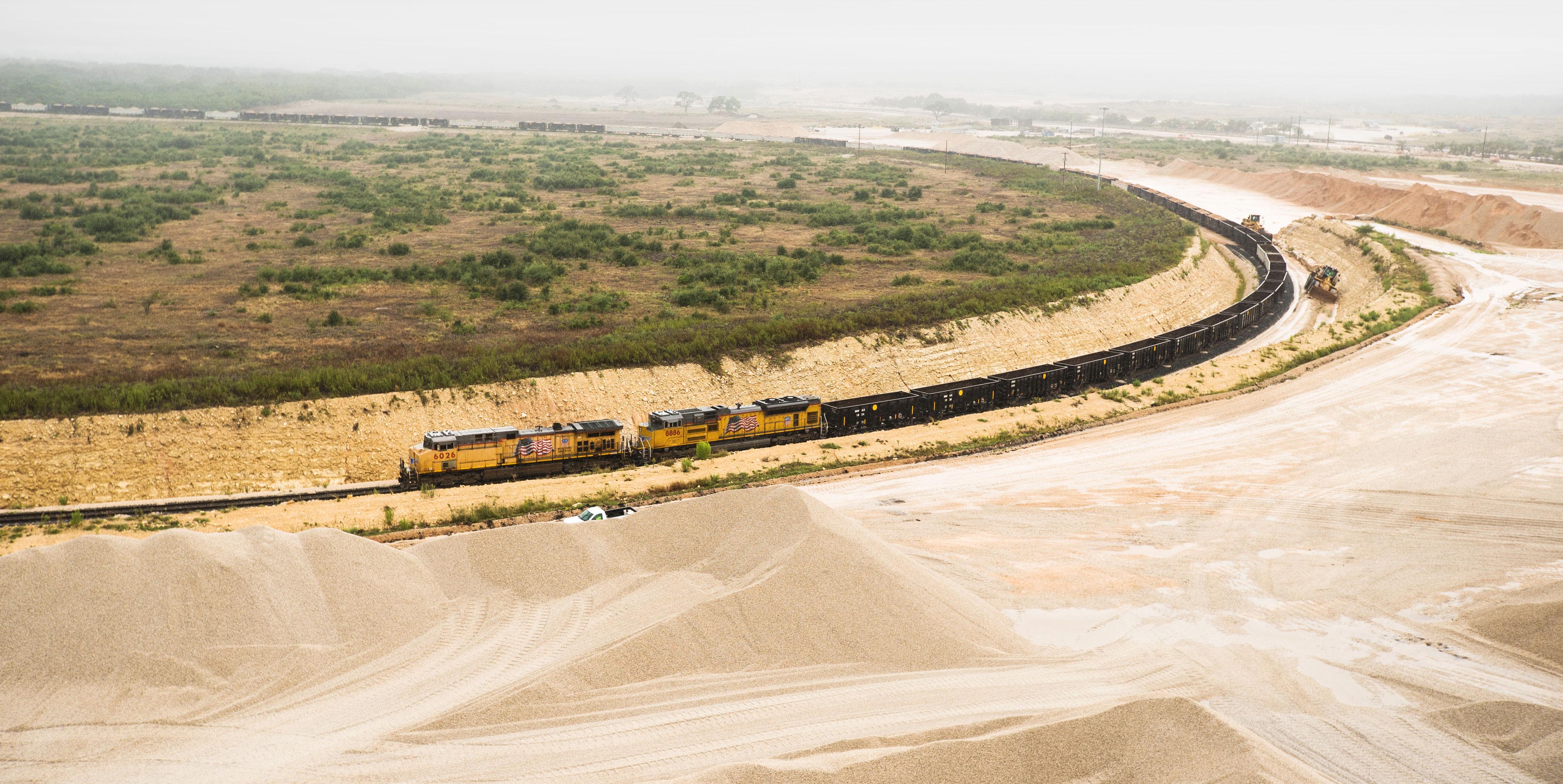 Union Pacific train passing Medina Rock and Rail facility.