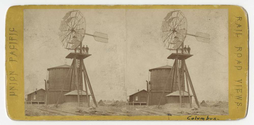 A stereo card showing a windmill and water tower located in Columbus, Nebraska